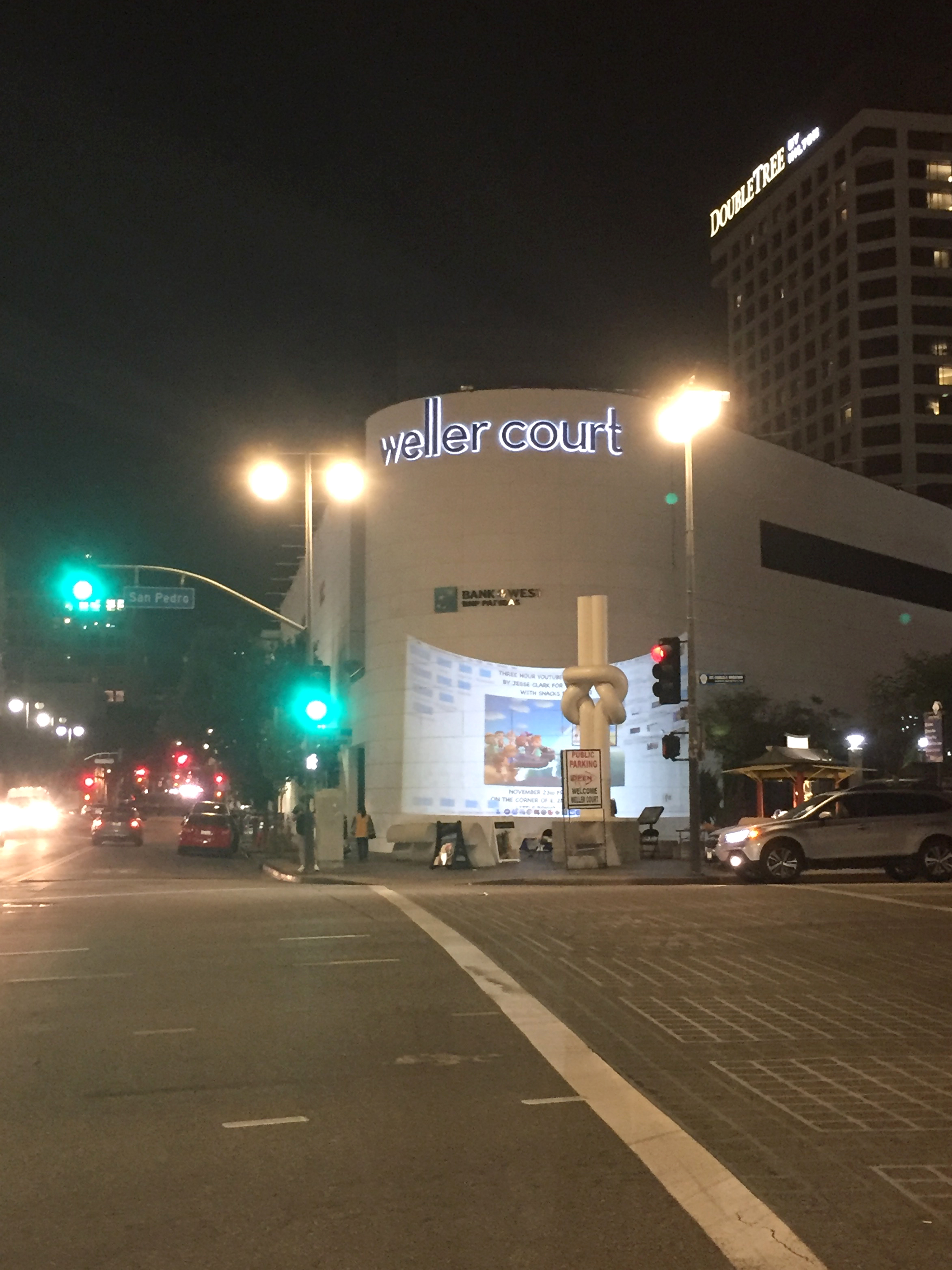 A corner in Little Tokyo, Los Angeles with a projection on a bank building